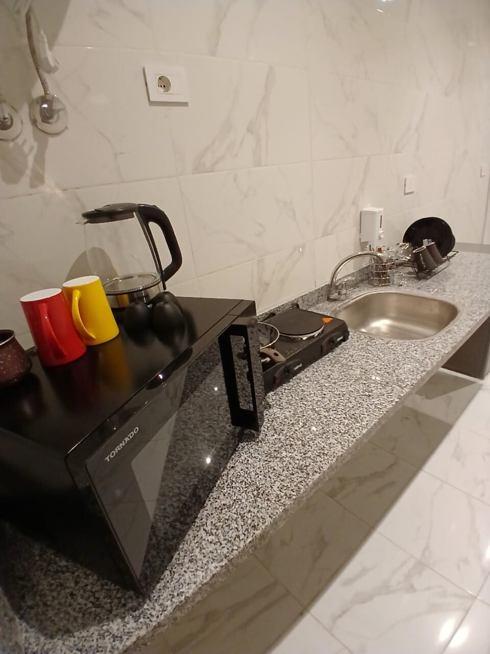 Kitchenette — counter with kettle and microwave